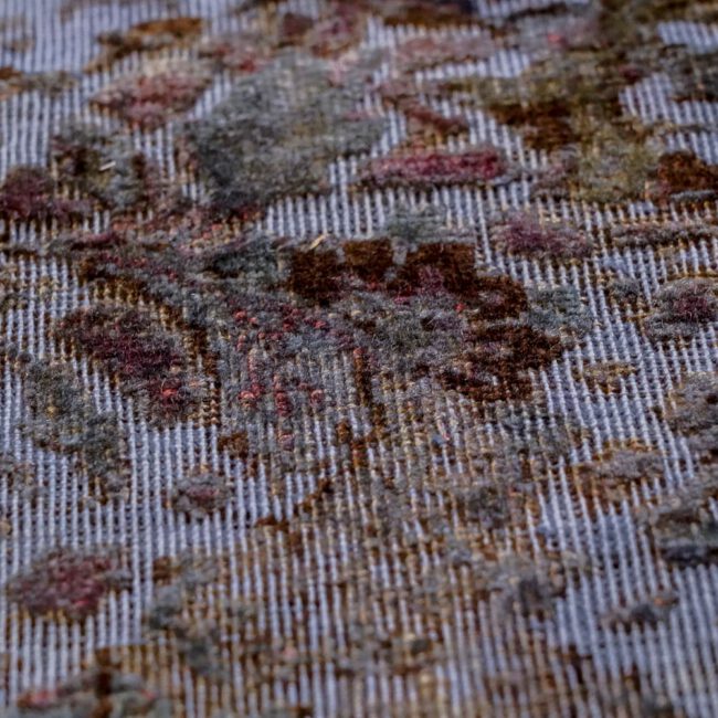 Close Up eines Persian Art Edition Teppich mit blau-lila Webfaden und buntem Muster